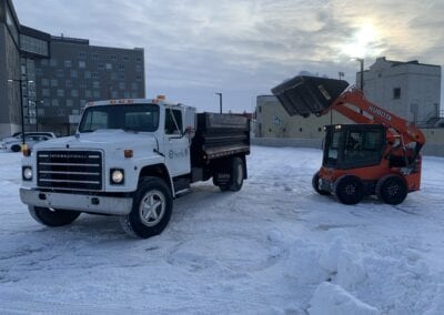 Loader loading snow in the truck