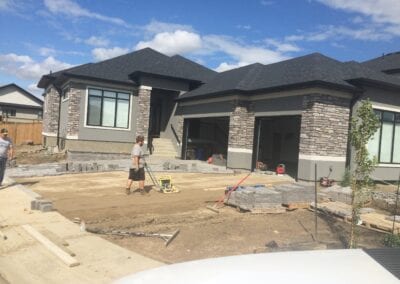 Workers levelling the surface for setting the pavers